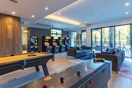 modern-game-room-with-pool-table-arcade-games-lounge-seating_1380686-3572